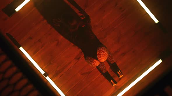 Top View to Sexy Lady Dancing Modern Dance  Twerk in Glowing Square of Led Yellow Lamps on Floor alt