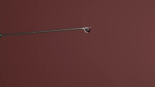 Syringe Needle with Liquid Dripping Drops of Medication in Slow Motion 240 Fps alt