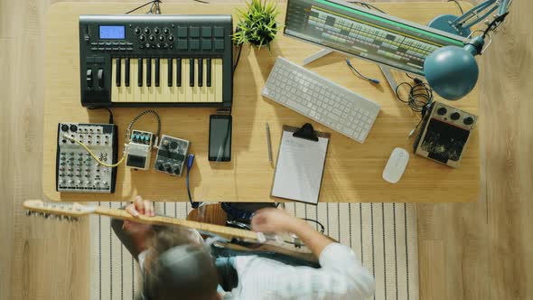 Zoomin Time Lapse of Creative Guy Recording Music Playing Instruments Guitar and Keyboard