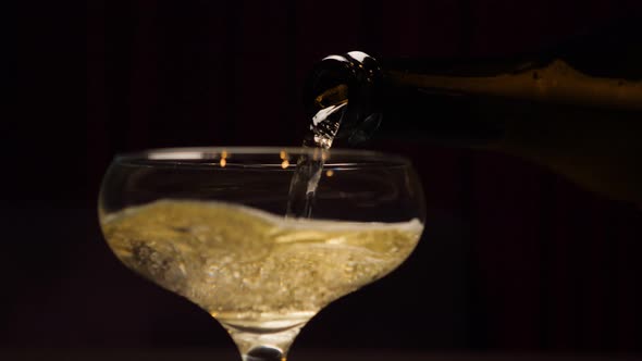 Bottle Champagne Slow Pouring in Glass Closeup alt