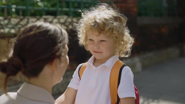 Mother Asking Her Son About His First Day at School alt