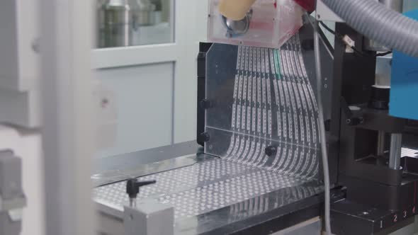 Automated Drug Production Machine Packs Pills Into Plastic Containers