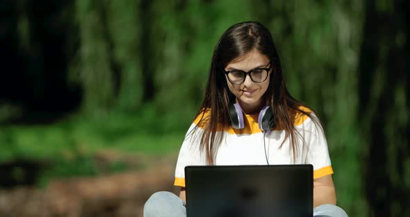 Woman Working on Laptop in Park