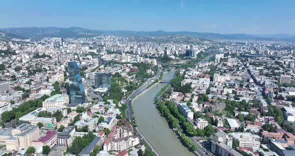 Tbilisi, Georgia - June 7 2022: Flying over  kura river in the center of Tbilisi city alt