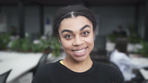 Happy Young Black Woman Looking To The Camera And Smiling