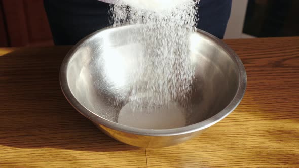 Pouring sugar into a bowl alt