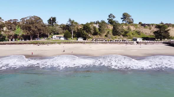 Foamy seawater hitting Seacliff State Beach in California. Aerial view alt