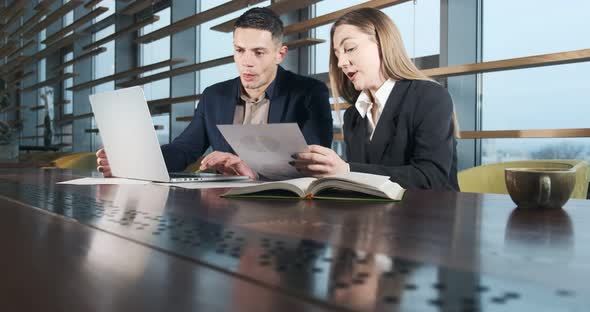 Man and a Woman Discussing Work in the Brightly Lit Modern Office. Concerned Male and Female Working alt