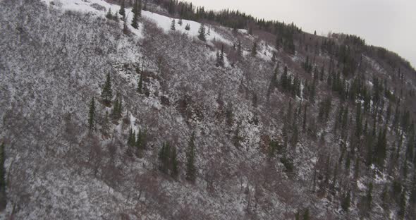 Aerial helicopter flying over bay towards city and mountains, drone footage