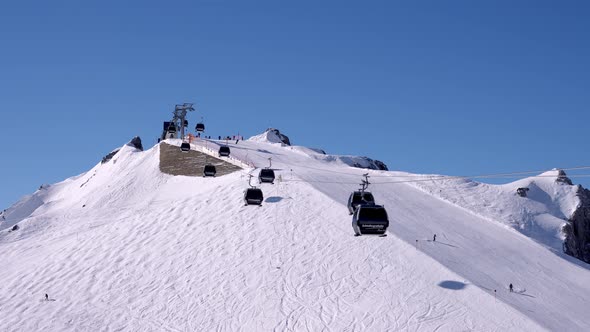 Ski Lift Moving Over Snowy Landscape in Austrian Alps alt