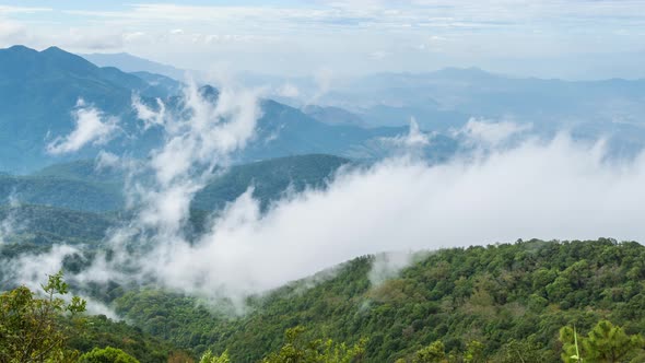 Clouds passing high mountains and tropical forest