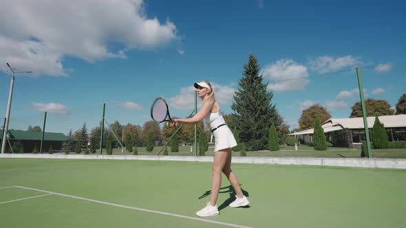 Professional Female Tennis Player Hits the Ball with a Racket Practice Game on the Tennis Court alt