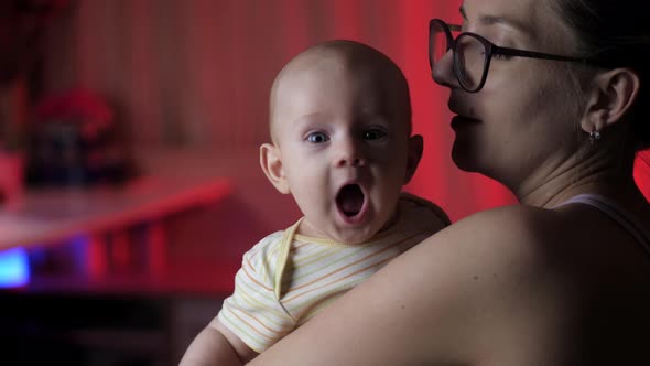 Mom and baby boy. Happy Mother holding her New born Baby kissing and hugging. alt
