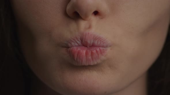 Close Up of a Caucasian Woman Lips Doing a Kiss and a Smile in Slow Motion alt