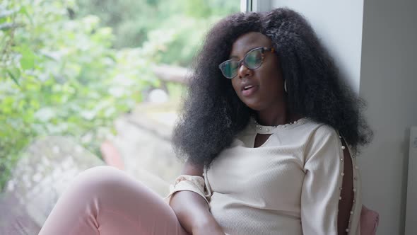 Young African American Woman Losing in Video Game Sighing Putting Away Joystick alt