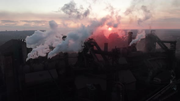 Drone Around Toxic Enterprise Chimneys Tubing Against the Sky Background Release Black Smoke