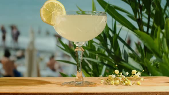 Glass of Daiquiri Cocktail Sea on Background alt