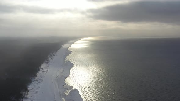 Winter shoreline of Baltic sea in Latvia at sunset