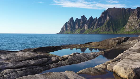 Beautiful Norwegian rocky coast and mountain ridge
