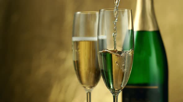 Super Slow Motion Shot of Pouring Champagne on Golden Luxury Background at 1000Fps alt