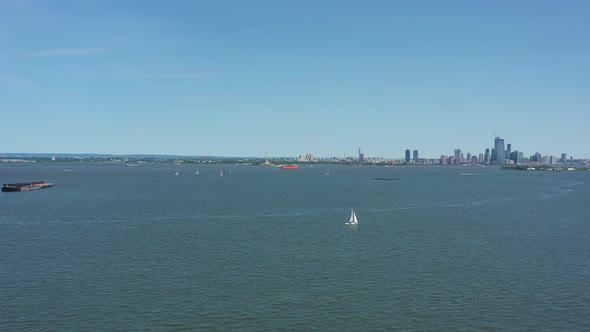 dolly shot towards lower Manhattan, high up over Upper New York Bay on a beautiful sunny morning alt