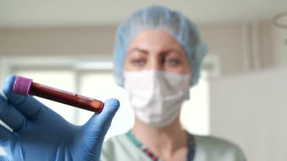 Nurse Is Shaking the Blood Sample alt