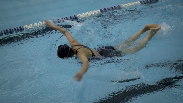 Female Amateur Swimmer Learning Butterfly Stroke In Swimming Pool