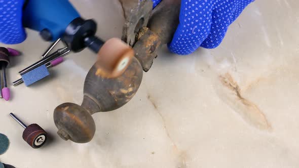 Grinding a figured tree with an emery wheel with an electric dremel.