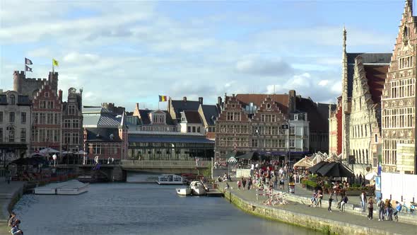 Gravensteen Castle and traditional buildings by the Grasburg Bridge and Leie River in Ghent, Belgium