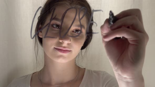 Sad Woman Writing CLOSED Sign on Glass Door Quarantine Concept