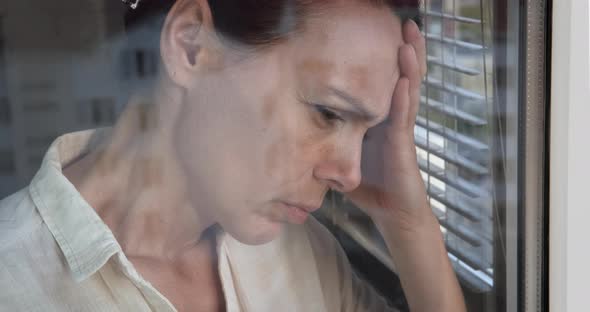 Tired Woman By Window alt