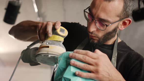 A male craftsman creates a decorative product with his own hands. Handmade, workshop. Creative alt