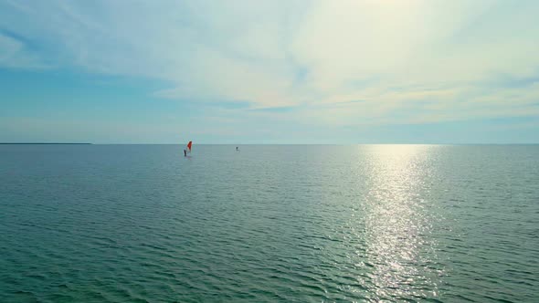 Aerial View Calm Sea Surface and Two Windsurfers alt