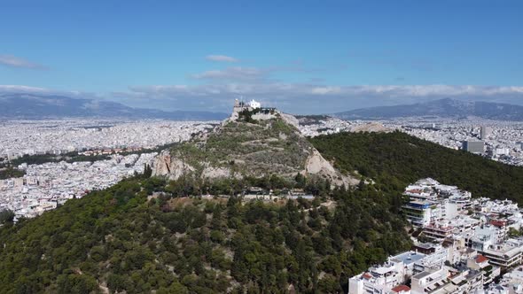 Aerial Drone Footage of Mount Lycabettus Surrounded By the Streets of Athens