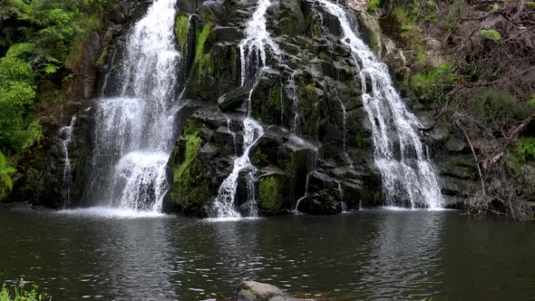 Slow wide revealing shot of Owharoa Falls near Karangahake Gorge in the Coromandel Peninsula of the alt