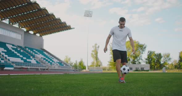 Professional Male Soccer Player Athlete on the Football Field in Slow Motion in Sports Equipment alt