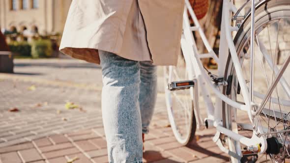 Back View of Unknown Ginger Lady Rolling Bicycle By Town Square alt