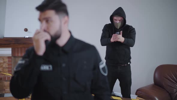 Bearded Caucasian Police Officer Taking on Radio Set When Criminal Pointing Guns on Him From the alt