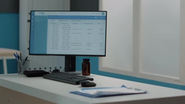 Close Up of Computer Screen with Patient Information on Desk alt
