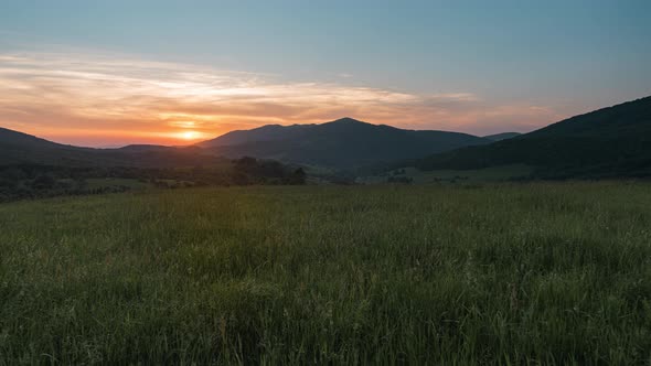 Colorful Sunset over Grass Field in Bieszczady Mountains, Poland