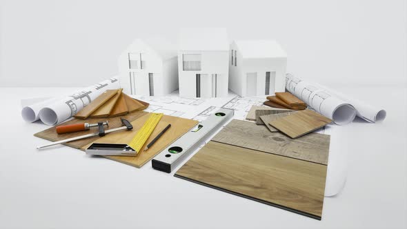 samples of wooden flooring, samplers of laminates, tiles and baseboards with carpenter tools on blue