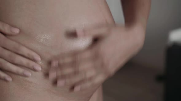 Bare Pregnant Moistens Tummy with Lotion alt