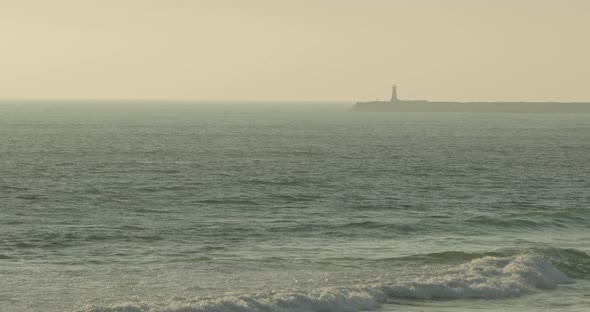 Distant View Of Cape Mondego Lighthouse On A Misty Morning In Figueira da Foz, Portugal. Wide Shot alt