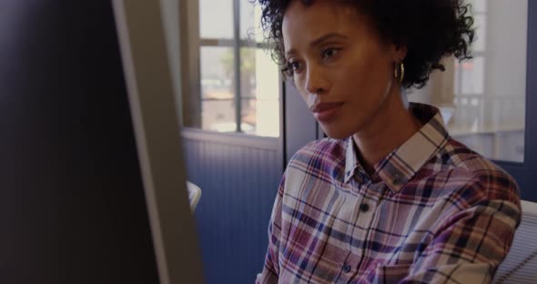 African American female graphic designer using graphics tablet in a modern office 4k