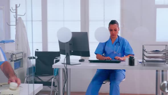 Team of Nurses Working Sitting Behind a Glass Wall alt