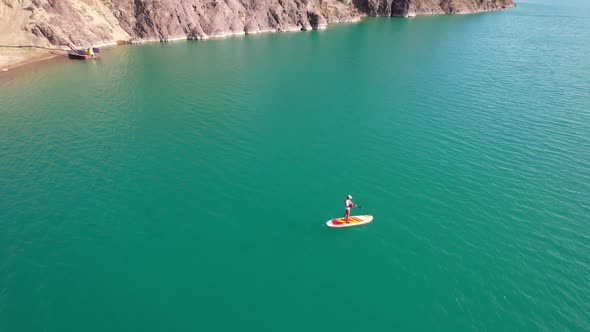 A Guy Goes Sup Surfing in a Lake Near the Shore alt