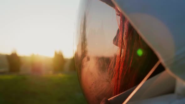 Female astronaut watching sunset through visor, close-up