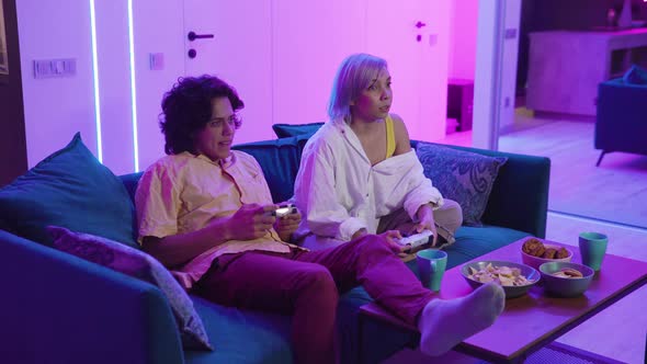 Beautiful Couple on a Date Indoors They Are Playing Video Games alt