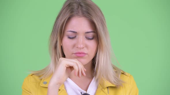 Face of Stressed Young Rebellious Blonde Woman Thinking and Looking Down alt