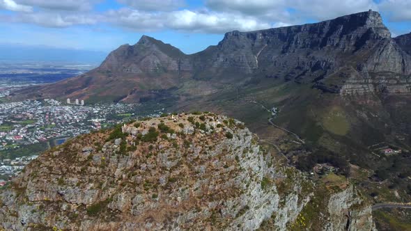 Drone shot of Lions Head in Cape Town - it is circling around the top of Lions Head, facing Table Mo alt